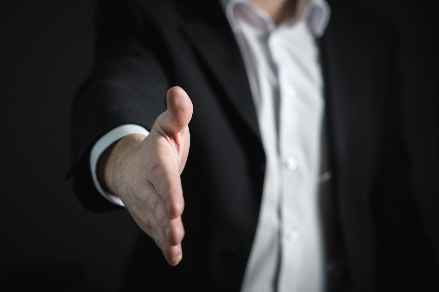 Man reaching out his hand as if to shake your hand